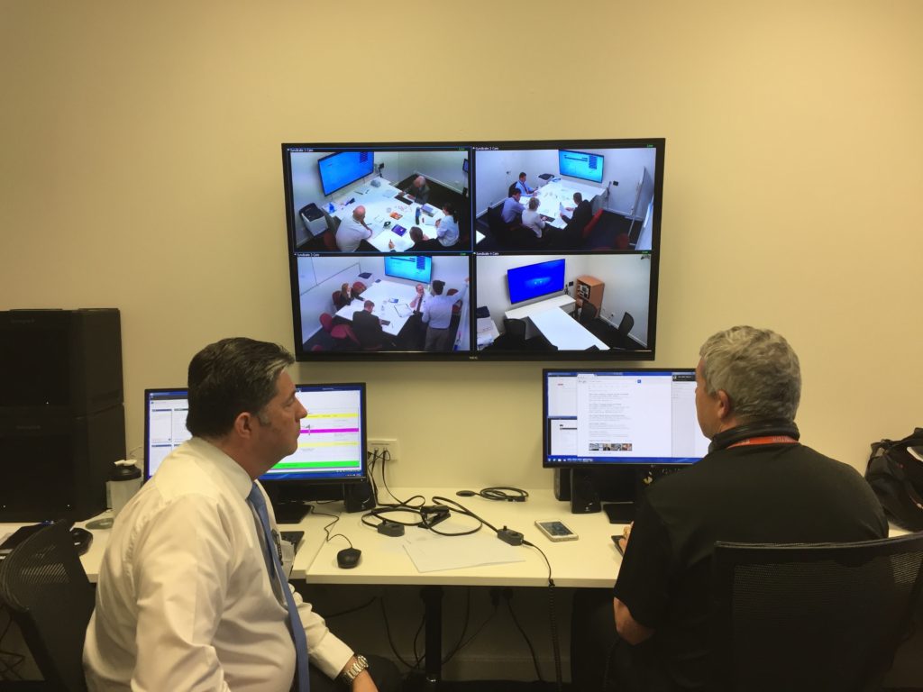 Two participants seated at a Hydra control workstation