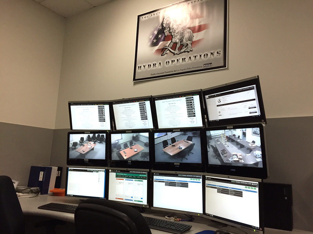 Hydra control station with multiple screens beneath a Los Angeles Police Department sign