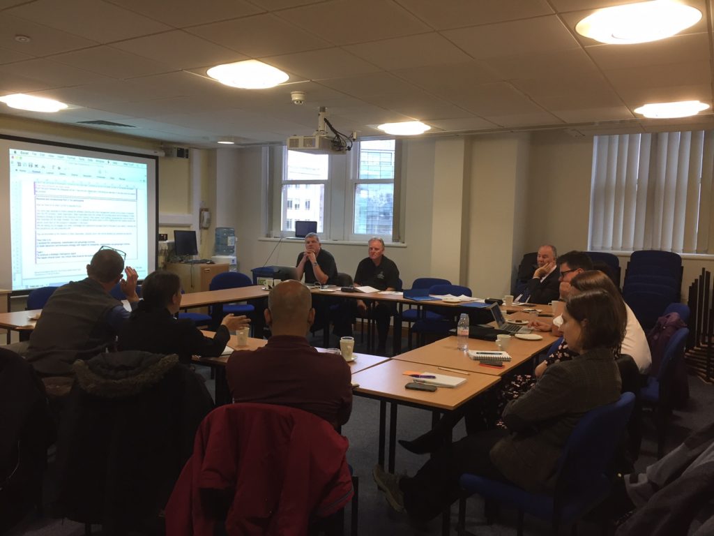 Workshop participants seated around a meeting table