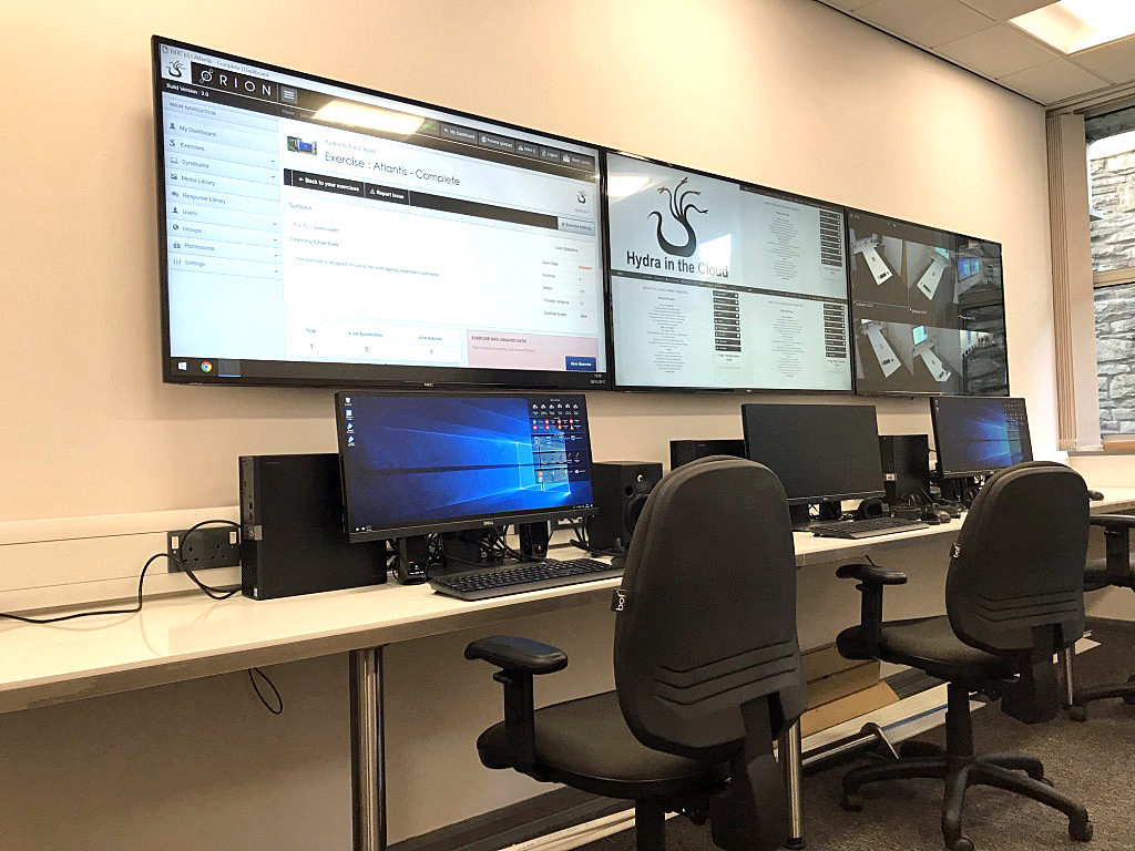 Hydra control room with workstations and wall-mounted displays