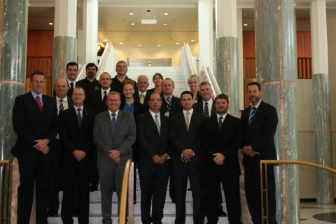 Group posing on an indoor staircase at Parliament House
